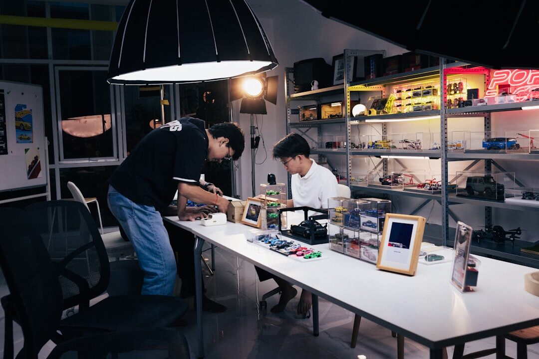Editorial team reviewing archival photographs at a large light table